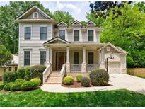 Charming two-story home with a welcoming front porch and manicured landscaping at 2370 Burch Cir, Brookhaven, GA 30319