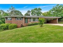 Charming brick home with a well-manicured lawn and covered carport at 14 Connie St, Cartersville, GA 30121