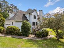 Charming home featuring a well-manicured lawn and a multi-level deck, perfect for outdoor enjoyment at 180 Butterfield Ln, Fayetteville, GA 30214