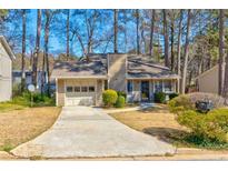 Charming single-story home featuring a one-car garage and a well-maintained front yard landscape at 2211 Jonathan Ave, Lithonia, GA 30058