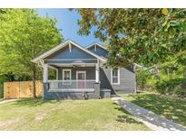 Charming bungalow featuring a covered front porch, fresh lawn and walkway at 1967 West John Calvin Ave, Atlanta, GA 30337