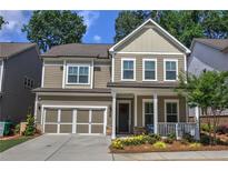 Charming two-story home with a well-manicured front yard and inviting front porch perfect for relaxing at 2657 Cedar Pine Way, Atlanta, GA 30360