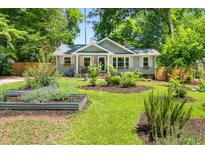 Charming single-story home with a well-manicured lawn and vibrant garden beds at 2272 Desmond Dr, Decatur, GA 30033