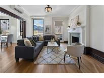Bright living room with hardwood floors, fireplace, and comfortable seating arrangement at 75 Ponce De Leon Ave # 701, Atlanta, GA 30308