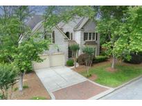 Beautiful two-story brick home with a two car garage and mature trees providing ample shade at 2250 Norbury Se Dr, Smyrna, GA 30080
