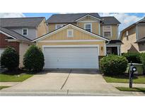 Charming two-story home with a two-car garage and well-maintained landscaping at 2428 Black Forest Dr, Conyers, GA 30012