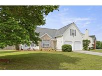 Charming two-story home with a well-maintained lawn and two-car garage, offering classic curb appeal at 3971 Canebrake Ln, Douglasville, GA 30134