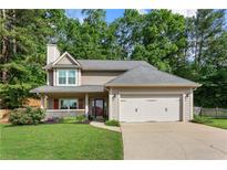 Charming two-story home with well-manicured lawn, a two-car garage, and mature landscaping at 4108 Berryhill Se Trce, Smyrna, GA 30082