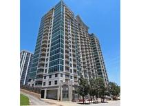 Luxury high-rise building featuring multiple balconies and modern architectural design against a clear blue sky at 250 Pharr Ne Rd # 208, Atlanta, GA 30305