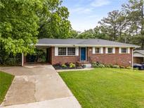 Charming brick home featuring a well-manicured lawn and tasteful landscaping at 2521 Whites Mill Ln, Decatur, GA 30032