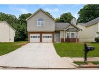 Charming two-story home with a two-car garage and well-maintained lawn and a brick facade at 4400 Old Allgood Cir, Stone Mountain, GA 30083