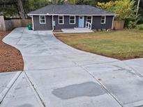 Charming single-story home with a freshly paved driveway and welcoming light blue front door at 2127 Whites Mill Rd, Decatur, GA 30032