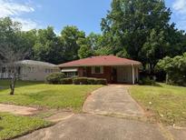 Charming single-story home with a brick facade, a red roof and a well-maintained front yard at 1275 Bell Ave, Atlanta, GA 30344