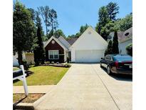 Charming single-story home with a well-manicured lawn, mature trees and a two-car garage at 2550 Kentshire Way, Lawrenceville, GA 30044
