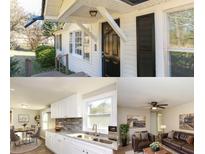 Charming home with a black front door, covered entryway, light-colored siding, and well-manicured landscaping at 272 Old Sudie Rd, Hiram, GA 30141