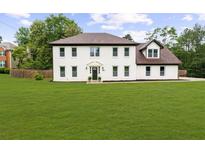 Elegant two-story white brick home with a lush green lawn and mature trees at 4605 Tims Pl, Snellville, GA 30039