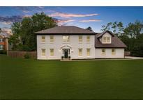 Charming two-story home with a lush green lawn and beautiful landscaping at 4605 Tims Pl, Snellville, GA 30039