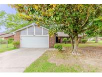 Charming single-Gathering home featuring a two-car garage and brick facade at 6715 Kimberly Mill Rd, Atlanta, GA 30349