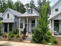 Charming home exterior with well-manicured landscaping and inviting front porch at 135 Mado Ln, Chattahoochee Hills, GA 30268