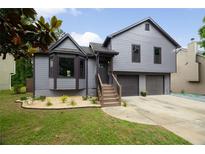 Charming gray two-story home featuring a well-manicured front yard and a two-car garage at 2872 Estuary Dr, Acworth, GA 30101
