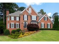 Beautiful brick home with manicured lawn and mature landscaping offers classic curb appeal at 3361 Woodington Se Ct, Marietta, GA 30067