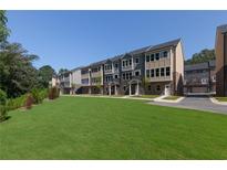 Exterior of newly built townhomes featuring manicured lawn and sidewalks at 3810 Jack Vernon Cir, Powder Springs, GA 30127