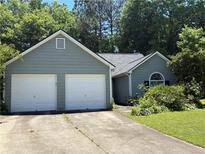 Charming single-story home featuring a two-car garage and lush landscaping in a serene neighborhood at 4302 Orange Court Nw Ct, Acworth, GA 30101