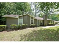 Ranch home featuring traditional styling, well-maintained landscaping and a symmetrical design at 5807 Christopher Ln, Lithonia, GA 30058