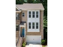 Beautiful brick townhome with a two-car garage and a charming blue front door at 1036 Grant Park Rd, Decatur, GA 30033