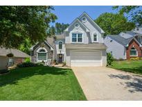 Charming two-story home with a well-manicured lawn and a two-car garage at 1777 Chasewood Park Ln, Marietta, GA 30066