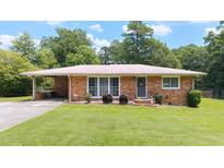 Charming brick home with a well-maintained lawn and inviting curb appeal at 4065 Old Austell Rd, Powder Springs, GA 30127