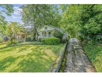Charming bungalow with a covered front porch and mature landscaping at 1311 Sylvan Cir, Brookhaven, GA 30319