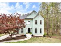 Charming two-story home features a black front door, manicured lawn, and beautiful landscaping at 1772 Brittany Chase Nw, Kennesaw, GA 30152
