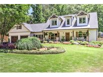 Charming two-story home with a manicured lawn and beautiful landscaping at 125 Foxridge Rd, Atlanta, GA 30327