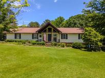 Charming ranch-style home with a well-manicured lawn and established landscaping at 3769 Bay Creek Church Rd, Loganville, GA 30052