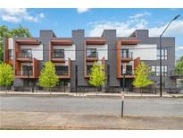 Modern townhome with sleek architectural details, balconies and landscaped greenery in a vibrant urban setting at 367 Parkway Ne Dr # 5, Atlanta, GA 30312