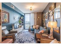 Comfortable living room featuring a modern sectional, city views, and stylish decor at 3040 Peachtree Nw Rd # 1013, Atlanta, GA 30305