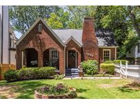 Charming brick home with a cozy front porch and well-maintained landscaping at 1055 Woodland Se Ave, Atlanta, GA 30316