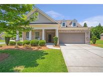 Charming brick home with a well-manicured lawn and a two-car garage at 2920 Farmstead Way, Suwanee, GA 30024