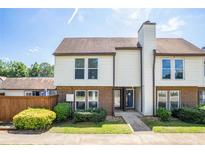Charming two-story townhouse with a brick facade, complemented by vinyl siding and a well-manicured lawn at 3210 Quincetree Lane Ln, Decatur, GA 30034