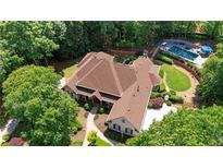 Aerial shot of the luxurious estate, showcasing the home's layout, pool, and landscaped grounds at 10630 N Edgewater Pl, Johns Creek, GA 30097