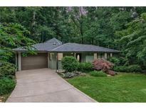 Charming single-story home with well-maintained landscaping and a driveway leading to an attached garage at 2786 Overlook Ne Dr, Atlanta, GA 30345