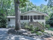 Charming home featuring a screened-in porch and mature trees at 543 S Holly Springs Rd, Woodstock, GA 30188