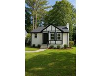 Charming home with manicured lawn, black trim, and inviting front entrance at 1658 Altadena Sw Pl, Atlanta, GA 30311