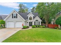 Charming two-story home with a manicured lawn, two-car garage, and lovely curb appeal at 5355 Wyntree Ct, Peachtree Corners, GA 30071