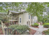 Charming townhome with a spacious covered porch, lush landscaping, and inviting entry way at 2901 Lenox Rd # 702, Atlanta, GA 30324