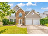 Charming two-story home featuring a stone facade, well-manicured lawn, and a two-car garage at 3816 Harris Nw Blvd, Kennesaw, GA 30144