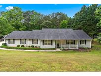 Charming ranch-style home with a well-manicured lawn and inviting front porch at 4274 Timber Trace Road, Loganville, GA 30052