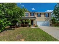 Charming two-story home with a well-manicured lawn and a two car garage at 7250 Old Chapel, Atlanta, GA 30349