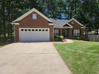 Charming brick home with a well-manicured lawn, attached garage, and inviting front entrance at 6788 Oakhurst Court Ct, Douglasville, GA 30134
